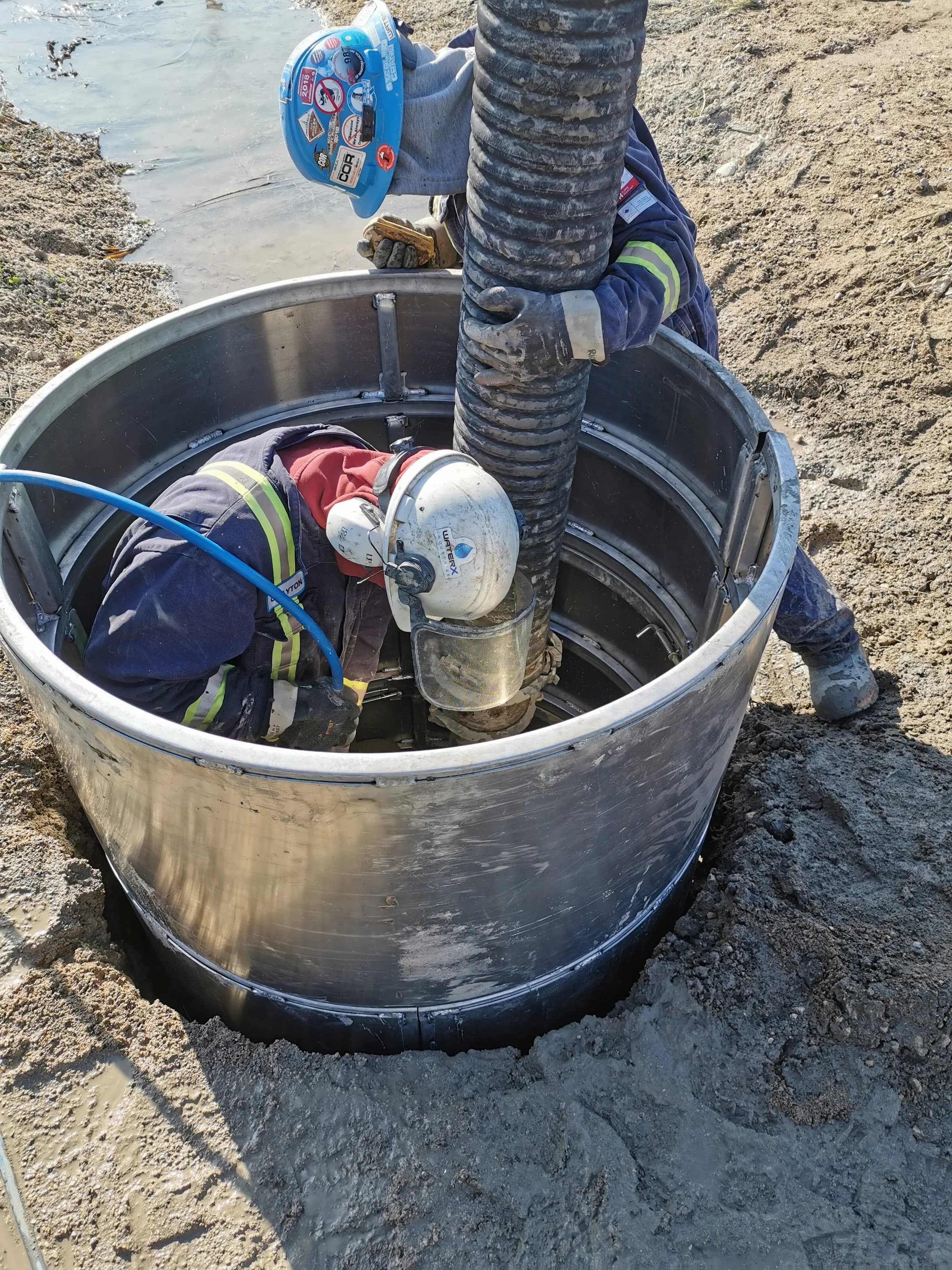 Worker safely inside an EasyDig circular trench cage